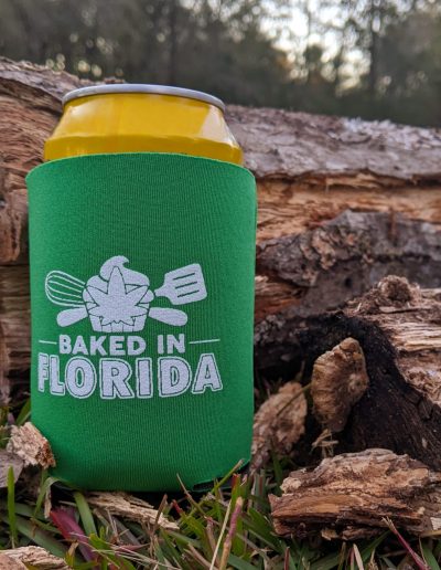 baked in Florida koozie in the woods